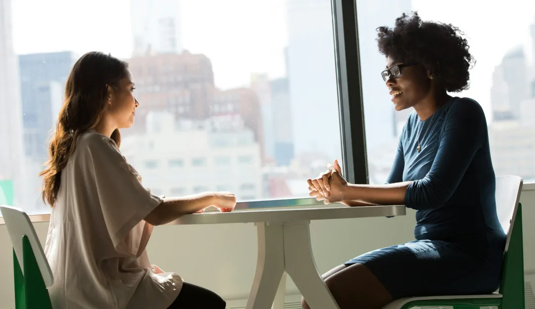 Two women discussing career opportunities